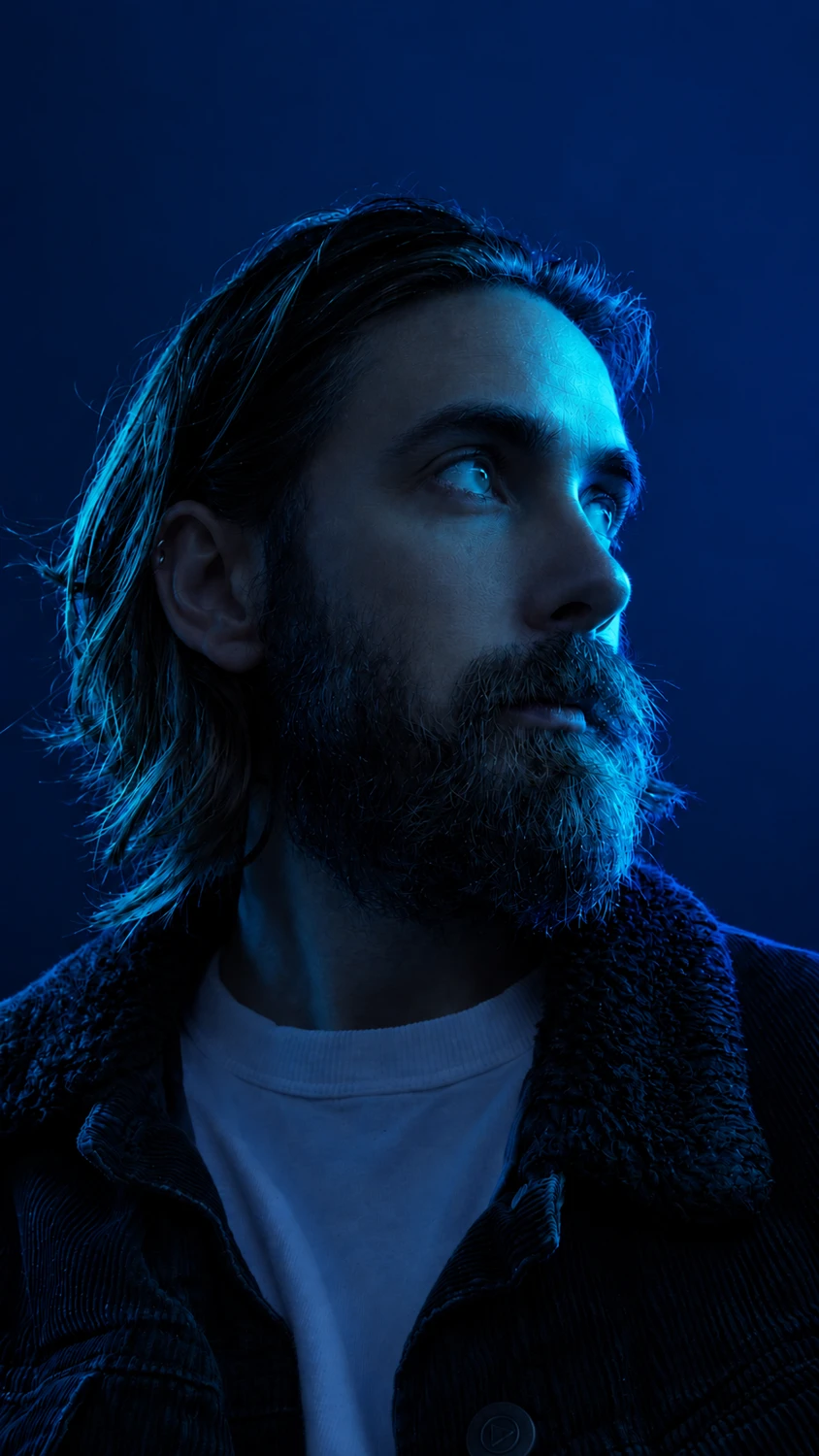 Mert Atakan in a blue-lit portrait